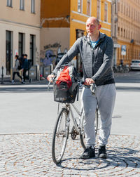 Portrait of a handsome hipster man. a man in a big city cycling down the street on a bicycle