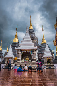 Group of people in front of building against sky