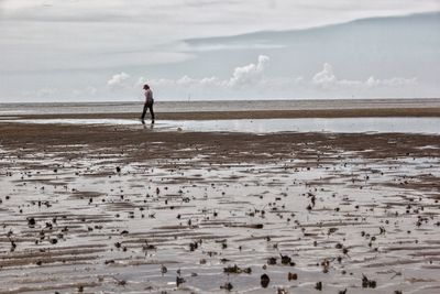 Full length of man on beach against sky