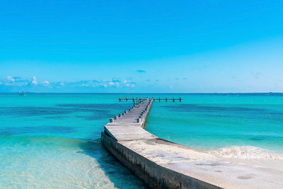 Scenic view of wooden jetty over sea against sky during summer