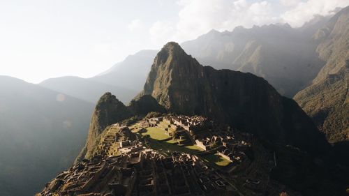 Machu picchu by rocky mountains against sky