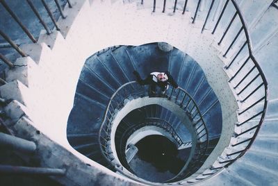 High angle view of man on spiral staircase
