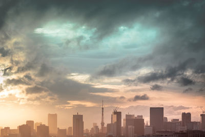 Modern buildings in city against sky during sunset in tokyo japan.