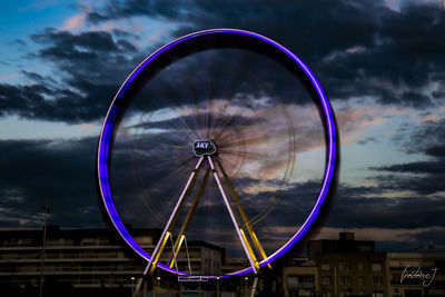 Ferris wheel against sky in city