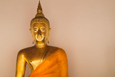 Close-up of buddha against wall