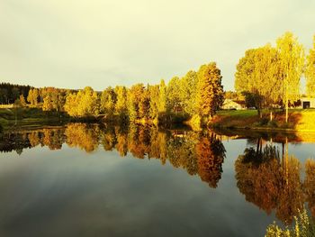 Reflection of trees in lake against sky during autumn