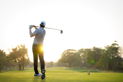 Rear view of man playing golf