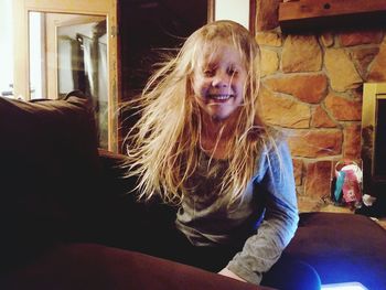 Portrait of smiling girl sitting at home