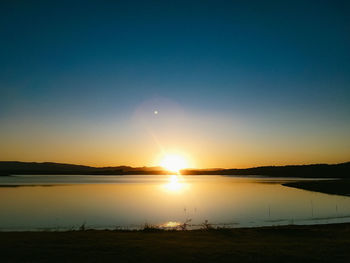 Scenic view of lake against sky during sunset