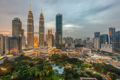 High angle view of buildings against cloudy sky