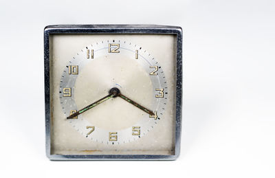 Close-up of clock on white background
