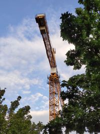 Low angle view of crane against sky