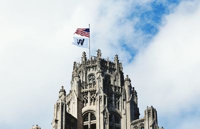 Low angle view of flags against sky