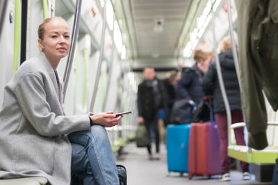 Portrait of woman sitting in subway train