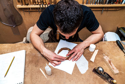 High angle view of man working on table