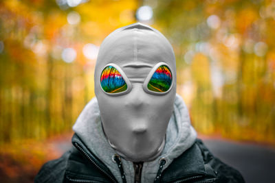 Grey alien in autumn forest