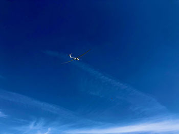 Low angle view of airplane flying in sky