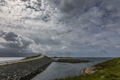 Road by sea against sky