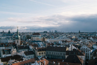 Cityscape against cloudy sky