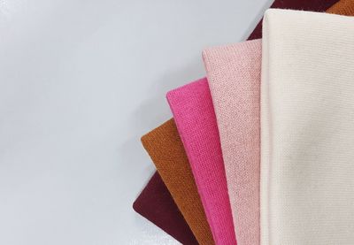 High angle view of multi colored paper on white background