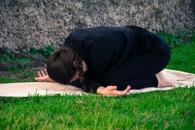 Midsection of woman lying on land