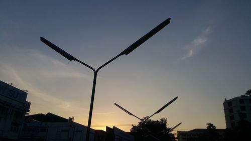 Low angle view of silhouette buildings against sky during sunset