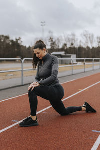 Woman exercising at running track