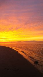 Scenic view of beach against sky during sunset