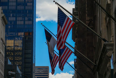 Low angle view of flag against buildings in city