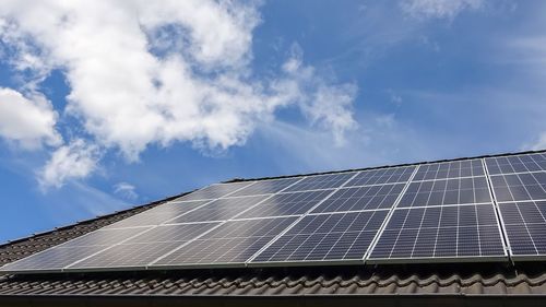 Solar panels producing clean energy on a roof of a residential house