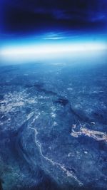 Aerial view of sea against blue sky