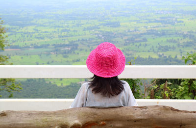 Rear view of woman sitting on landscape