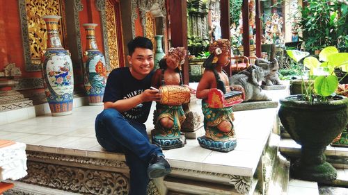 Portrait of smiling man sitting in temple