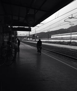 People walking on railroad track