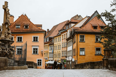 Low angle view of buildings in town against sky