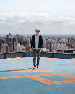 Full length of woman standing on city against sky