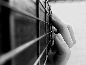 Close-up of hand playing guitar