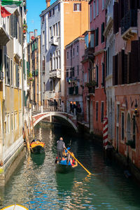 Boats in canal along buildings