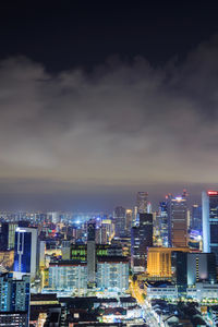 Illuminated cityscape against sky at night