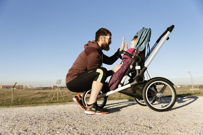 Side view of man riding bicycle on road