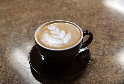 High angle view of cappuccino on table