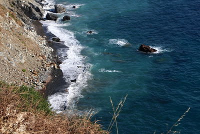 High angle view of rocks in sea