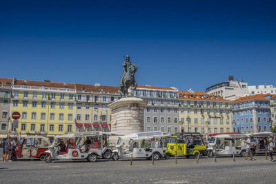 Statue in city against clear sky