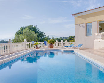 View of swimming pool by building against sky