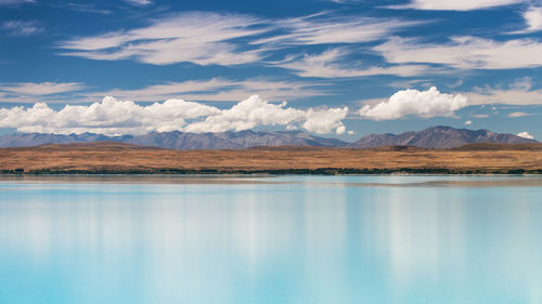 Scenic view of lake and mountains against sky