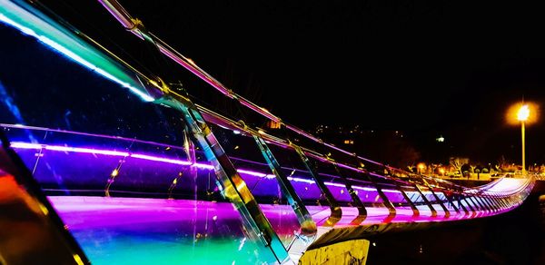 Light trails in city against clear sky at night