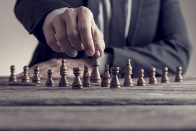 Low section of man playing on chess board