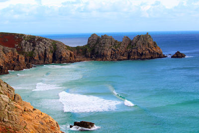 Scenic view of rocks in sea against sky