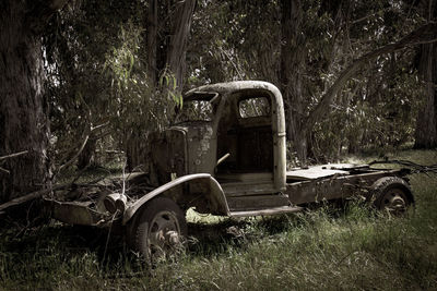 Abandoned vintage car on field