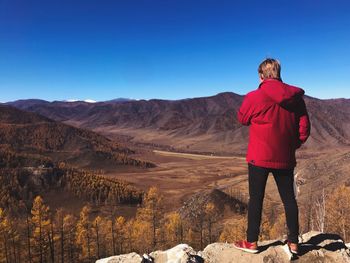 Full length of man standing on mountain during winter